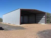 50' x 100' x 20' open ended custom kit building erected on 18 inch x 10' x 36 inch baled piers.