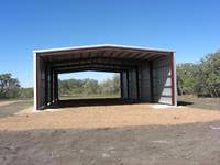 50' x 100' x 20' open ended custom kit building erected on 18 inch x 10' x 36 inch baled piers.